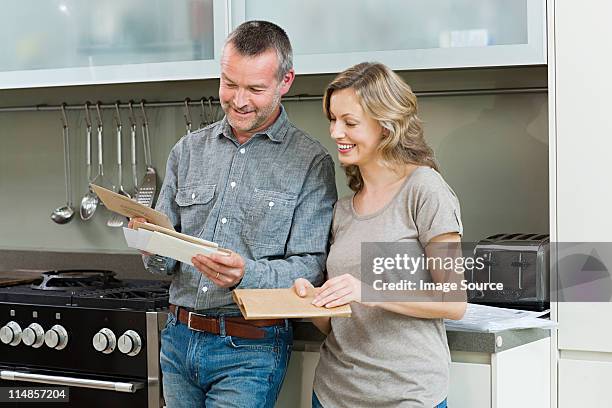 mature couple with letters - happy surprise stock pictures, royalty-free photos & images