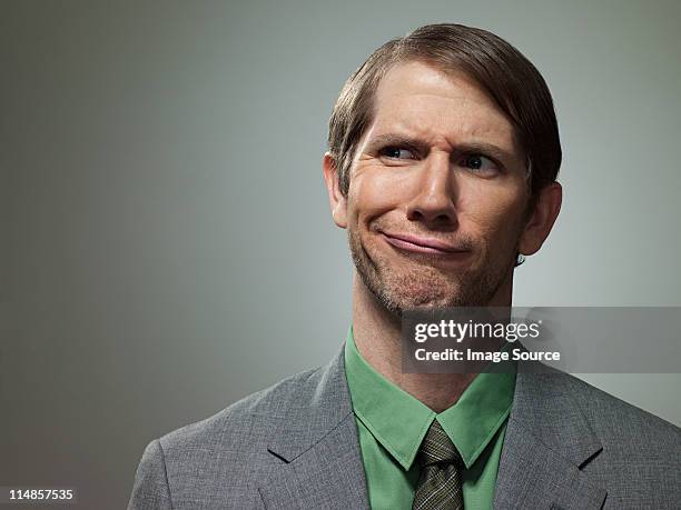 confused mid adult businessman, portrait - verward stockfoto's en -beelden