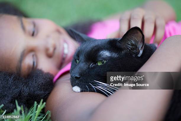 girl cuddling cat - girls cuddling cat stock pictures, royalty-free photos & images