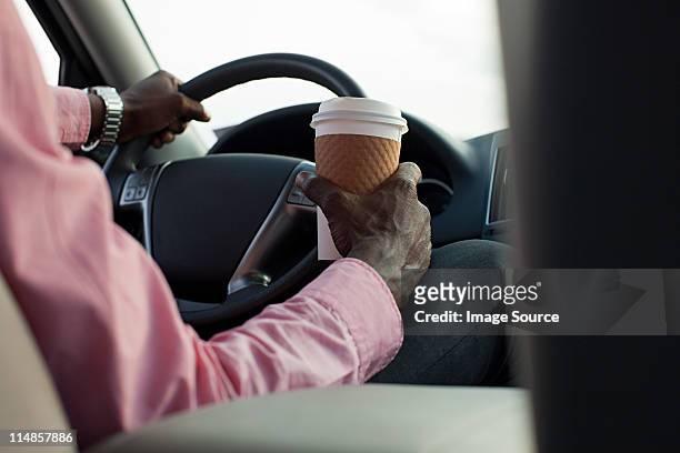businessman driving car with disposable cup - drink driving stockfoto's en -beelden