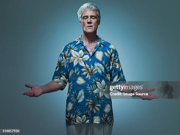 senior man wearing hawaiian shirt posing as jesus, portrait - hawaiian shirt 個照片及圖片檔
