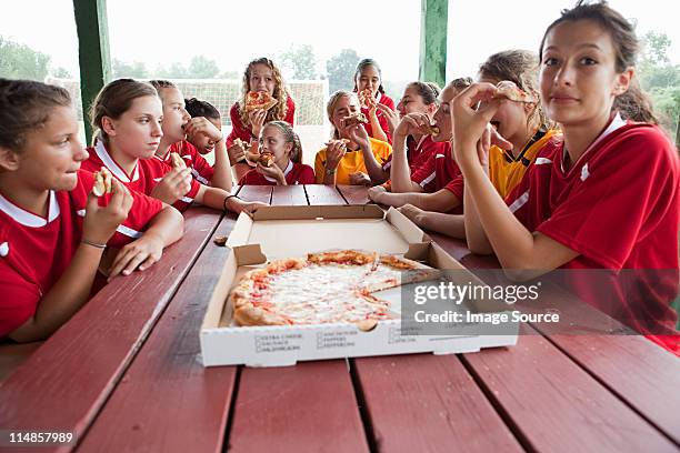 female soccer team having pizza - chatham new york state stock pictures, royalty-free photos & images