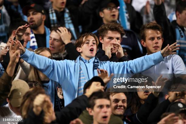 Sydney FC fans show their colours during the A-League Semi Final match between Sydney FC and the Melbourne Victory at Netstrata Jubilee Stadium on...