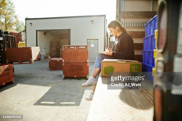 double checking the details of delivery - receiving delivery stock pictures, royalty-free photos & images