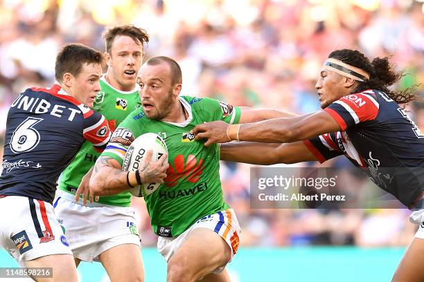 Josh Hodgson of the Raiders is tackled during the round nine NRL match between the Sydney Roosters and the Canberra Raiders at Suncorp Stadium on May...