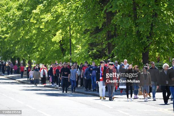 Fans arrive at the stadium prior to the Premier League match between Manchester United and Cardiff City at Old Trafford on May 12, 2019 in...