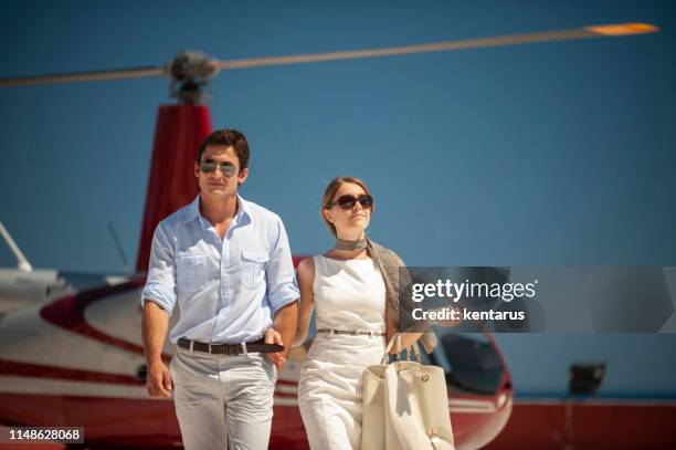 family couple on vacation trip by helicopter - helicopter money stock pictures, royalty-free photos & images