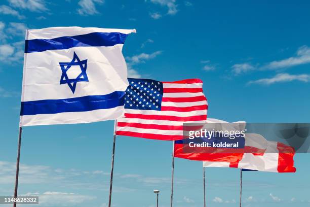 national flags of israel, usa , russia , england and france against blue sky waving in the wind - israel flag - fotografias e filmes do acervo