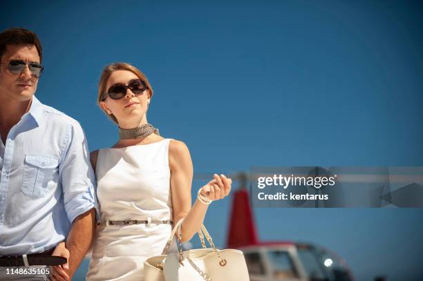 rich couple came on a holiday trip by helicopter - helicopter money stock pictures, royalty-free photos & images