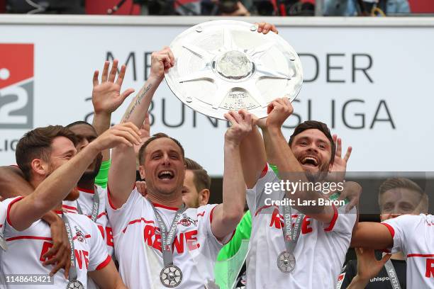 Matthias Lehmann and Jonas Hector of FC Koeln lift the Second Bundesliga trophy at the end of the Second Bundesliga match between 1. FC Koeln and SSV...