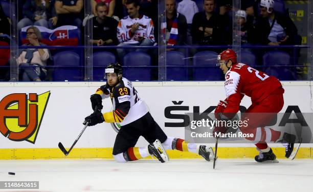 Oliver Lauridsen of Denmark challenges Leao Draisaitl of Germany during the 2019 IIHF Ice Hockey World Championship Slovakia group A game between...