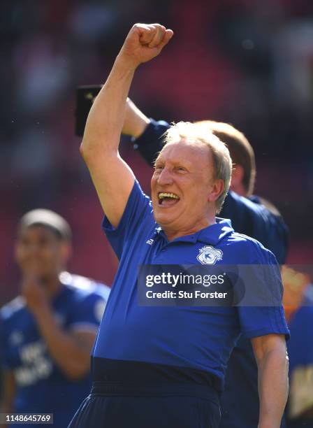Cardiff manager Neil Warnock celebrates with the fans after the Premier League match between Manchester United and Cardiff City at Old Trafford on...