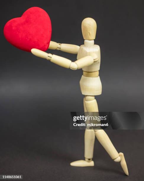 mannequin holding a red heart - diamond doll stock pictures, royalty-free photos & images
