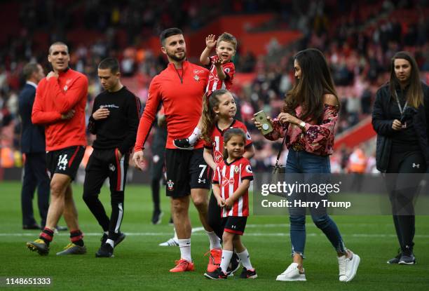 Shane Long of Southampton walks round the pitch with his family during a lap of celebration during the Premier League match between Southampton FC...
