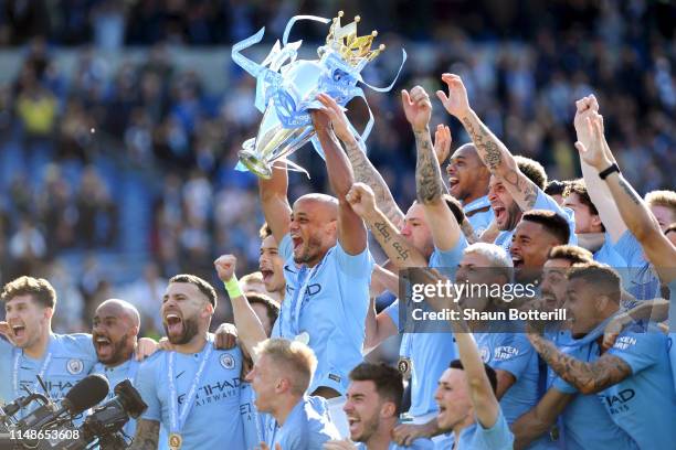 Vincent Kompany of Manchester City lifts the Premier League Trophy after winning the title during the Premier League match between Brighton & Hove...