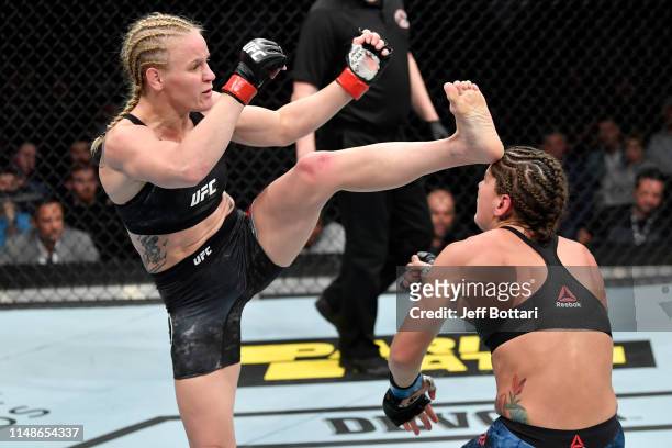 Valentina Shevchenko of Kyrgyzstan kicks Jessica Eye in their women's flyweight championship bout during the UFC 238 event at the United Center on...