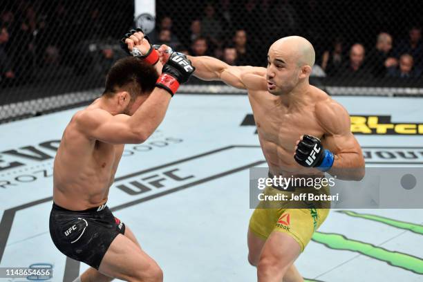 Marlon Moraes of Brazil punches Henry Cejudo in their bantamweight championship bout during the UFC 238 event at the United Center on June 8, 2019 in...