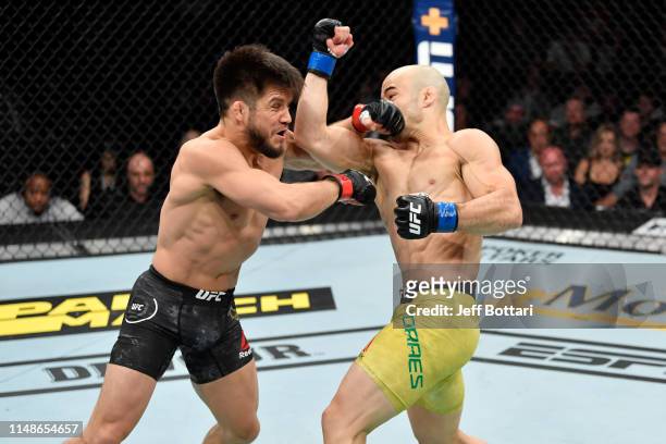 Marlon Moraes of Brazil punches Henry Cejudo in their bantamweight championship bout during the UFC 238 event at the United Center on June 8, 2019 in...