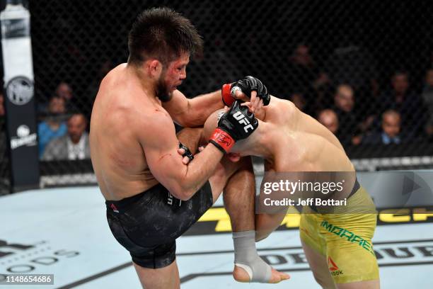 Henry Cejudo knees Marlon Moraes of Brazil in their bantamweight championship bout during the UFC 238 event at the United Center on June 8, 2019 in...