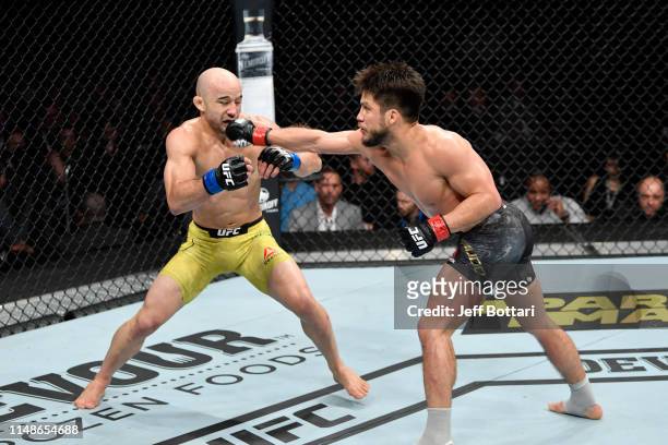 Henry Cejudo punches Marlon Moraes of Brazil in their bantamweight championship bout during the UFC 238 event at the United Center on June 8, 2019 in...
