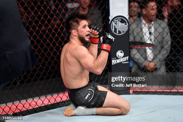 Henry Cejudo celebrates his victory over Marlon Moraes of Brazil in their bantamweight championship bout during the UFC 238 event at the United...