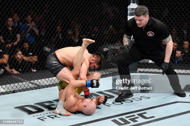 Henry Cejudo punches Marlon Moraes of Brazil in their bantamweight championship bout during the UFC 238 event at the United Center on June 8, 2019 in...