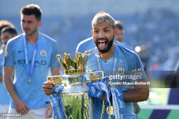 Sergio Aguero of Manchester City celebrates with the Premier League Trophy after winning the title following the Premier League match between...
