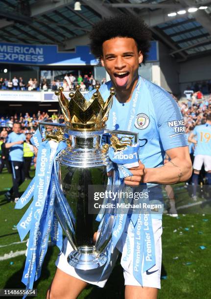 Leroy Sane of Manchester City celebrates with the Premier League Trophy after winning the title during the Premier League match between Brighton &...