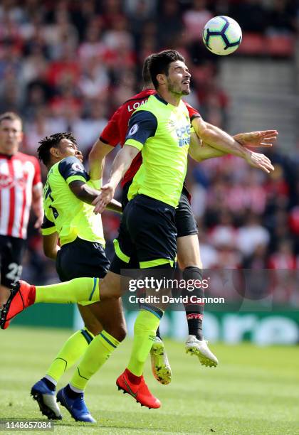 Christopher Schindler of Huddersfield Town clashes with Shane Long of Southmpton during the Premier League match between Southampton FC and...