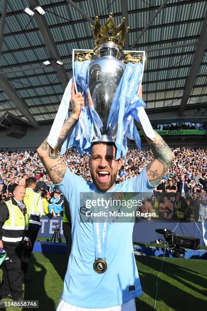 Nicolas Otamendi of Manchester City celebrates with the Premier League Trophy after winning the title following the Premier League match between...