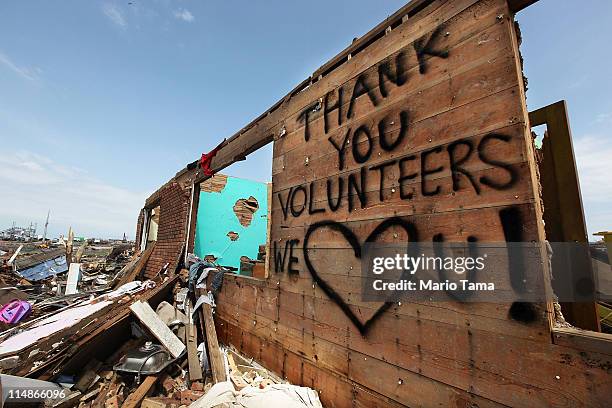 Thank you message to volunteers is seen onteh side of a building after a massive tornado passed through the town killing at least 132 people on May...