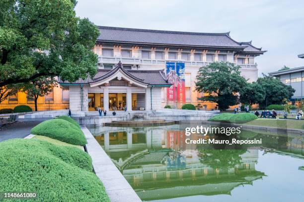 people walking next to the entrance of the honkan museum building that holds the japanese gallery in the tokyo national museum in the ueno park at the taito ward in tokyo city, japan. - tokyo national museum stock pictures, royalty-free photos & images