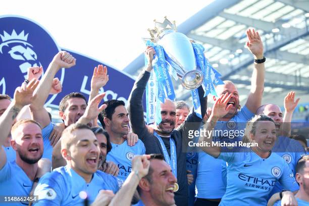 Josep Guardiola, Manager of Manchester City lifts the Premier League Trophy after winning the title during the Premier League match between Brighton...