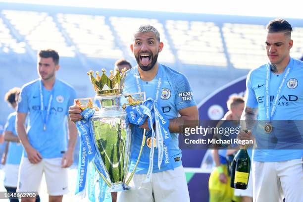 Sergio Aguero of Manchester City celebrates with the Premier League Trophy after winning the title following the Premier League match between...