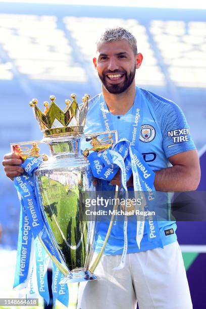 Sergio Aguero of Manchester City celebrates with the Premier League Trophy after winning the title after the Premier League match between Brighton &...