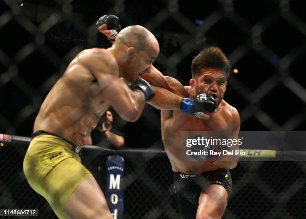 Marlon Moraes of Brazil punches Henry Cejudo in their bantamweight championship bout during the UFC 238 event at United Center on June 8, 2019 in...