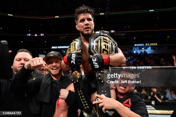 Henry Cejudo celebrates his TKO victory over Marlon Moraes of Brazil in their bantamweight championship bout during the UFC 238 event at the United...
