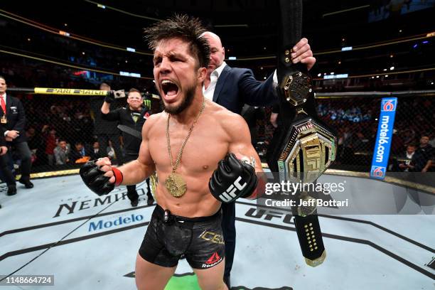 Henry Cejudo celebrates his TKO victory over Marlon Moraes of Brazil in their bantamweight championship bout during the UFC 238 event at the United...