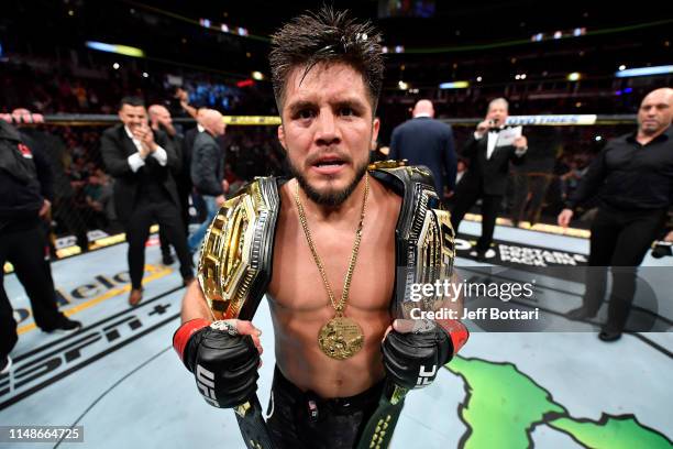 Henry Cejudo celebrates his TKO victory over Marlon Moraes of Brazil in their bantamweight championship bout during the UFC 238 event at the United...