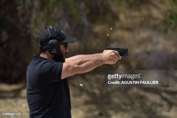 Rabbi Raziel Cohen, aka "Tactical Rabbi", shoots a Glock 9mm pistol during a demonstration at the Angeles Shooting Ranges in Pacoima, California on...