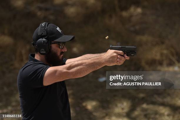 Rabbi Raziel Cohen, aka "Tactical Rabbi", shoots a Glock 9mm pistol during a demonstration at the Angeles Shooting Ranges in Pacoima, California on...