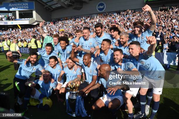 Fernandinho of Manchester City celebrates with the Premier League Trophy after winning the title during the Premier League match between Brighton &...