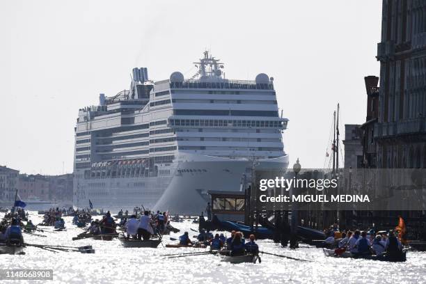 The MSC Magnifica cruise ship is seen in the Venice Lagoon on June 9 as people take to the water in the annual Vogalonga rowing regatta in Venice....