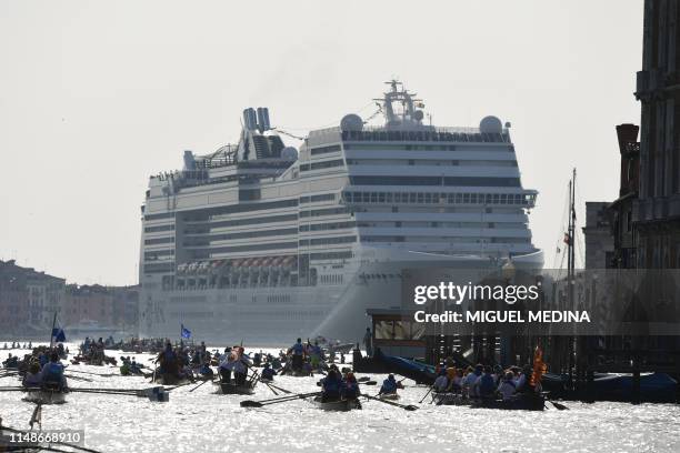 The MSC Magnifica cruise ship is seen in the Venice Lagoon on June 9 as people take to the water in the annual Vogalonga rowing regatta in Venice....