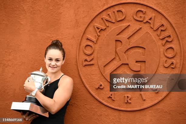 Australia's Ashleigh Barty poses with The Suzanne Lenglen trophy on day fifteen of The Roland Garros 2019 French Open tennis tournament in Paris on...
