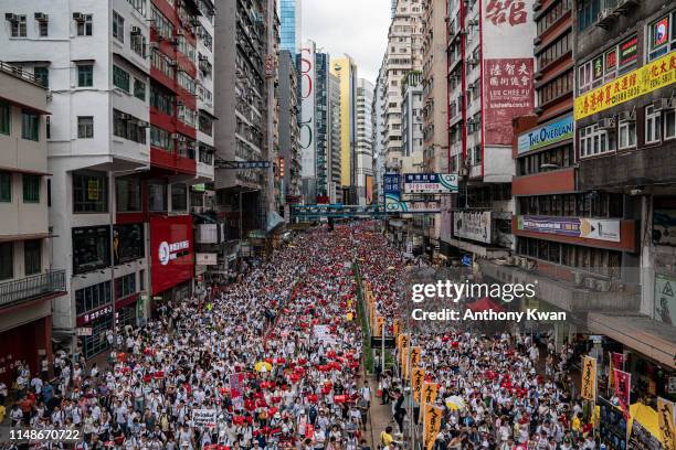 Protesters march on a street during a rally against the extradition law proposal on June 9, 2019 in Hong Kong. Hundreds of thousands of protesters...