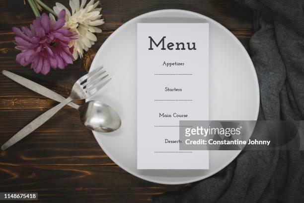 paper with menu on dining plate over rustic wood - white flower paper stock pictures, royalty-free photos & images