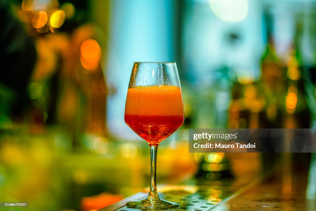 Glass of ice-cooled Spritz with orange