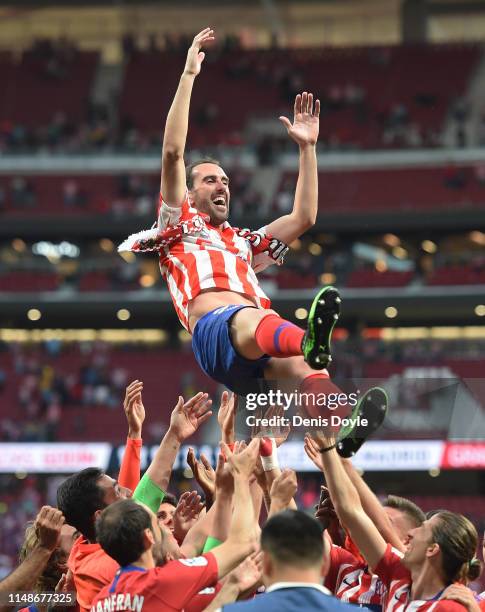 Diego Godin of Atletico Madrid is thrown into the air by his teammates during celebrations after his last home match for the club at the end of the...