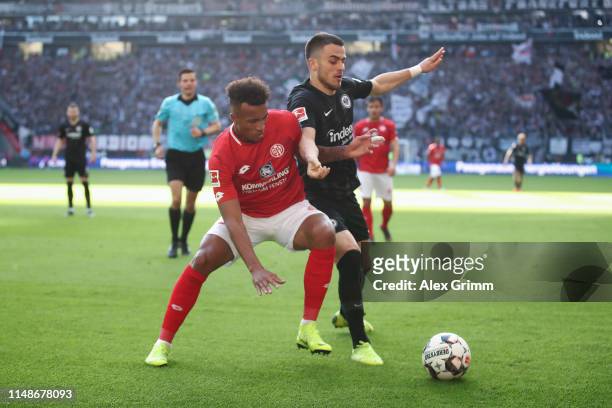 Jean-Philippe Gbamin of Mainz is challenged by Filip Kostic of Frankfurt during the Bundesliga match between Eintracht Frankfurt and 1. FSV Mainz 05...